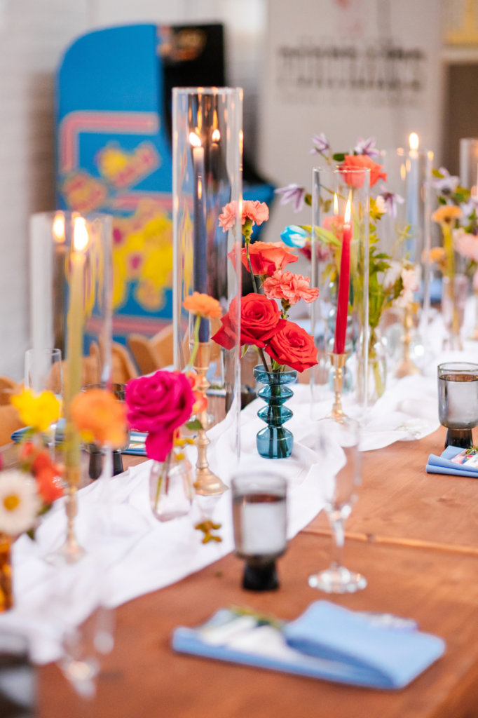 Colorful and eclectic wedding flower centerpiece with candles