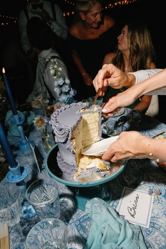 An eclectic, color-blocked tablescape of monochromatic blue fruit, flowers, and cake