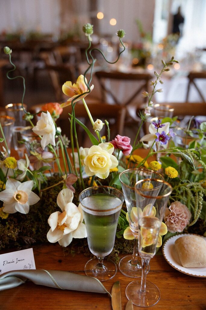 A spring floral garland table runner with a base of moss.