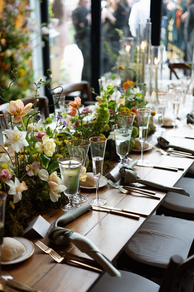 A spring floral garland table runner with a base of moss.