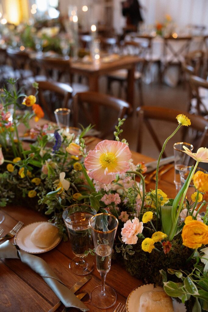 A spring floral garland table runner with a base of moss.