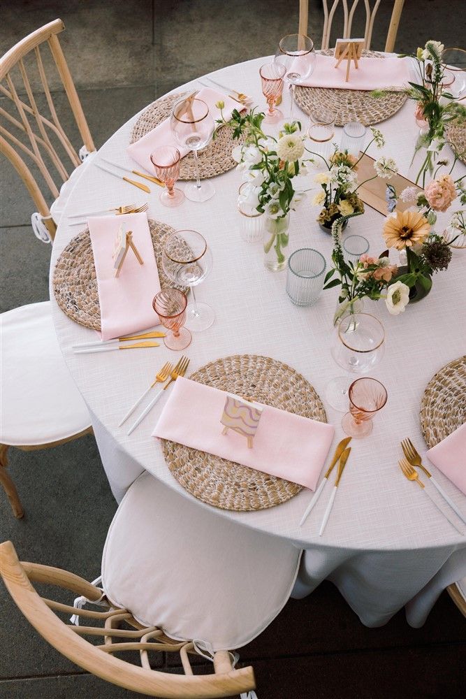 A mix of ikebana and bud vase arrangements as centerpieces at a wedding reception.