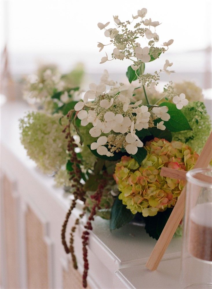 A dynamic hydrangea arrangement at the bar of a wedding reception.