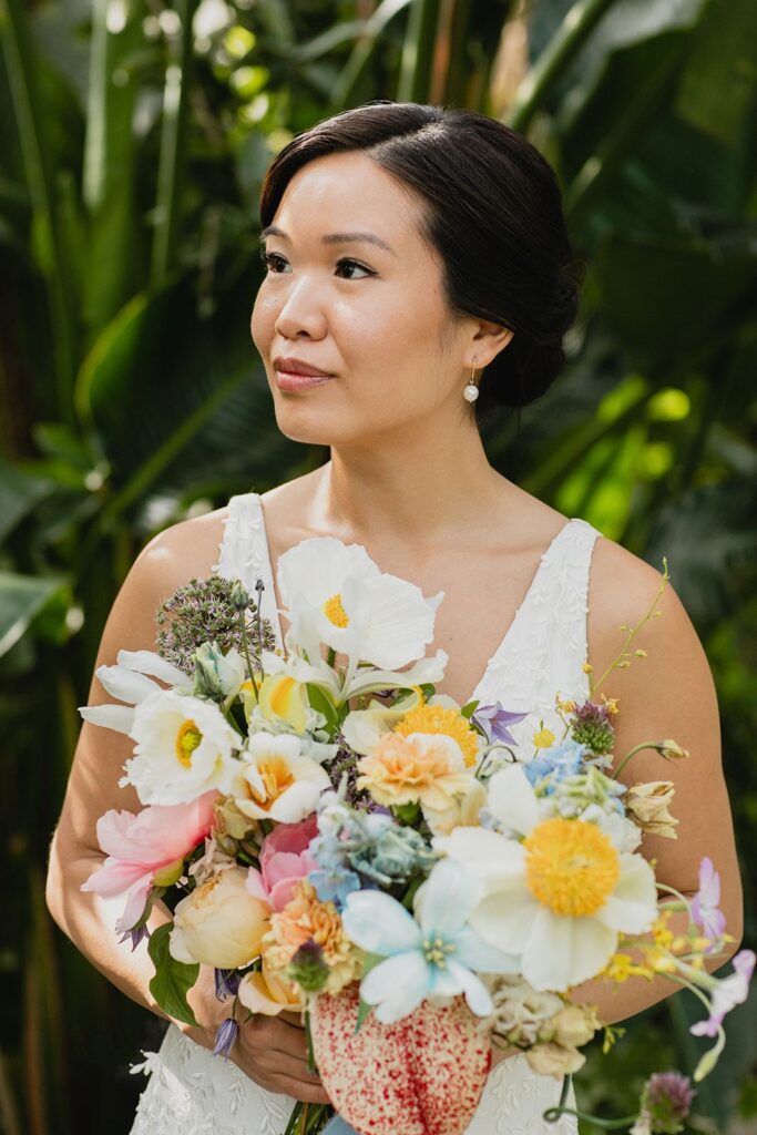 A bridal bouquet featuring claire de lune peonies, tulips, anthuriums, roses, and more.