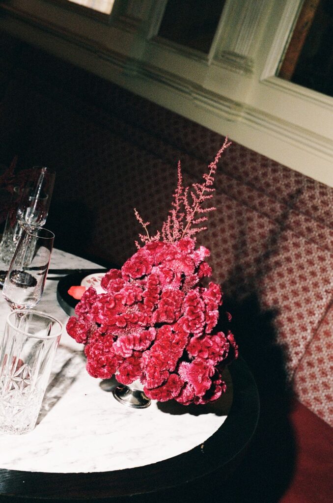 A red floral arrangement of brain celosia and astilbe.