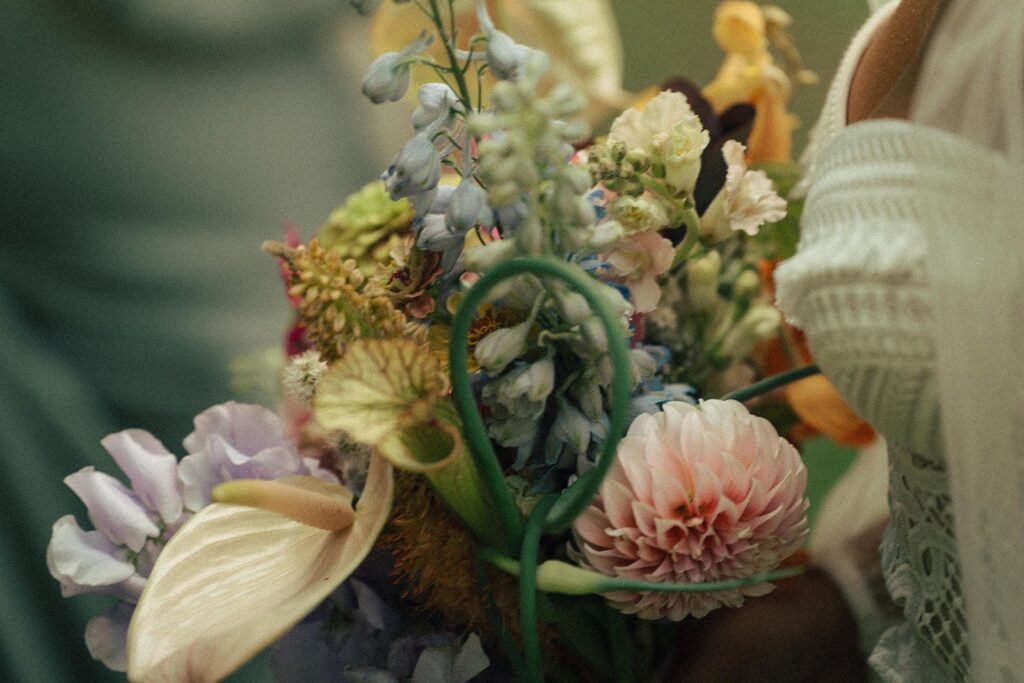 A bridal bouquet featuring dahlias, sarracenias, anthurium, allium, and more.