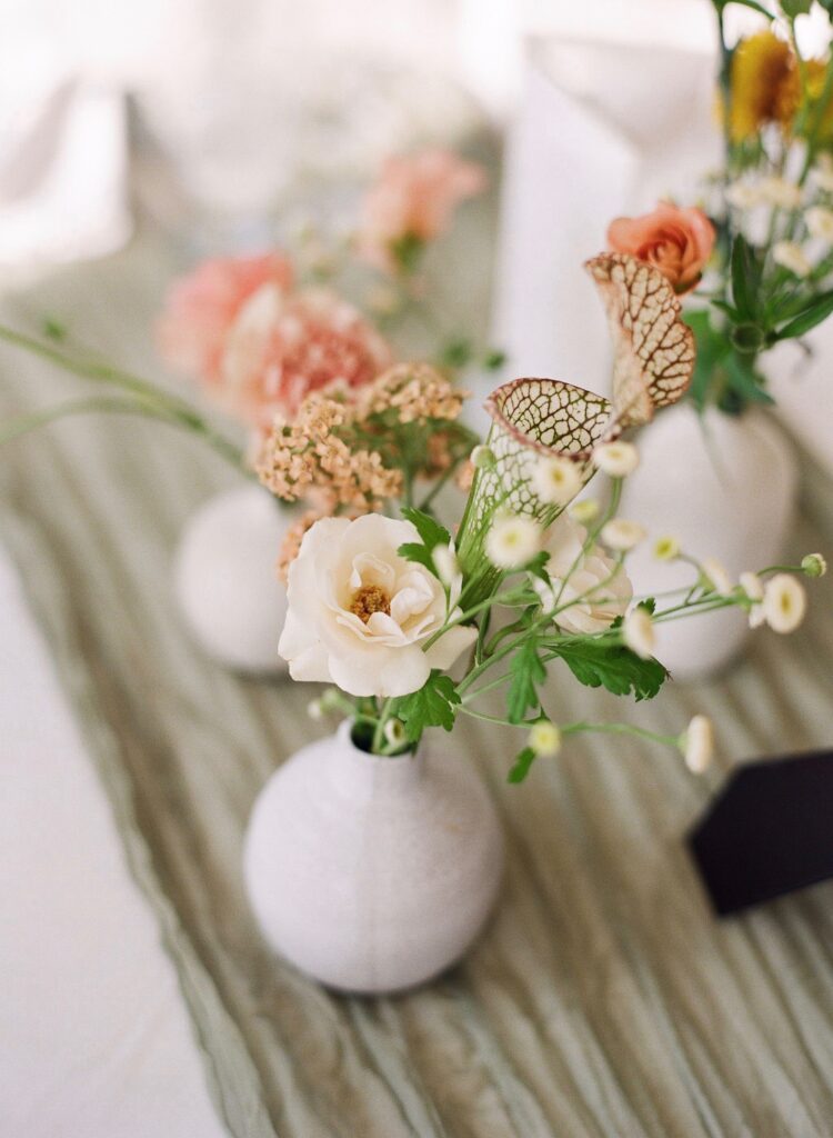 A bud vase arrangement with a rose, sarracenia, and more.