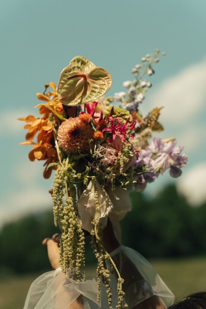 A bouquet of anthurium, dahlias, orchids, amaranthus, and more.
