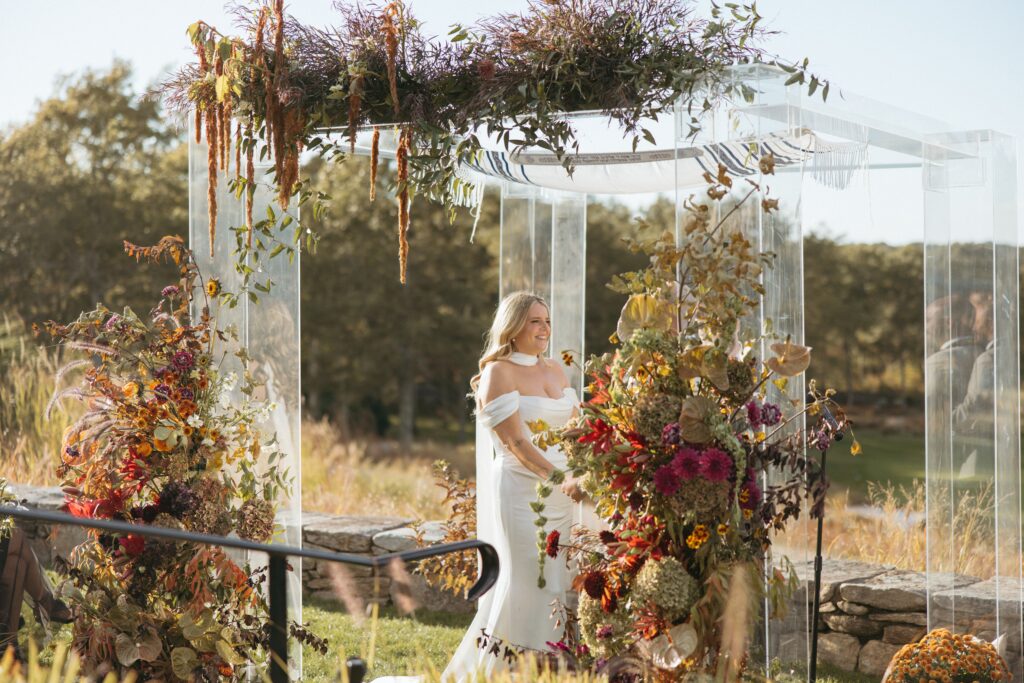 A fall floral wedding chuppah arrangement with hanging amaranthus.